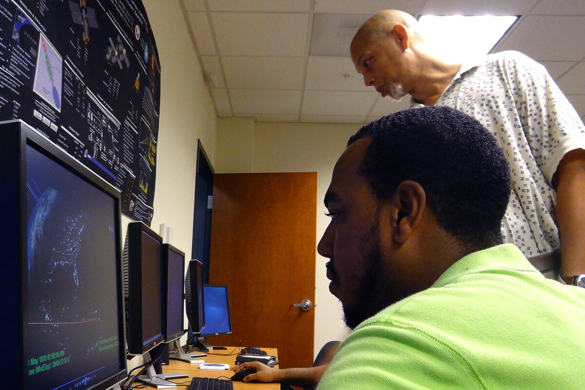 NIA Distinguished Langley Professor from North Carolina A&T, Dr. William Edmonson, reviews satellite simulations with graduate students